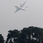 Wildfire puts Paris on alert as the Seine River becomes a key resource An aircraft flying over a forest engulfed in flames near Paris