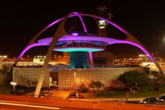 Alarm at LAX: Fire investigated after cargo plane lands A giant main tower at Los Angeles International Airport with many lights illuminating the outside of the structure