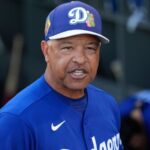 The Dodgers' manager with an angry expression while in the dugout with the rest of his players