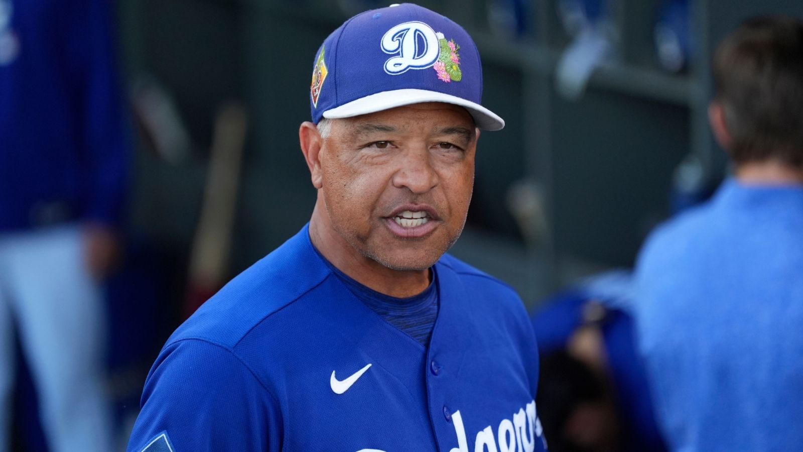 The Dodgers' manager with an angry expression while in the dugout with the rest of his players