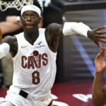 The German point guard staying in the air to make a basket while using his other hand to shield his opponent