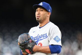 Díaz looking concerned while holding his glove during a game