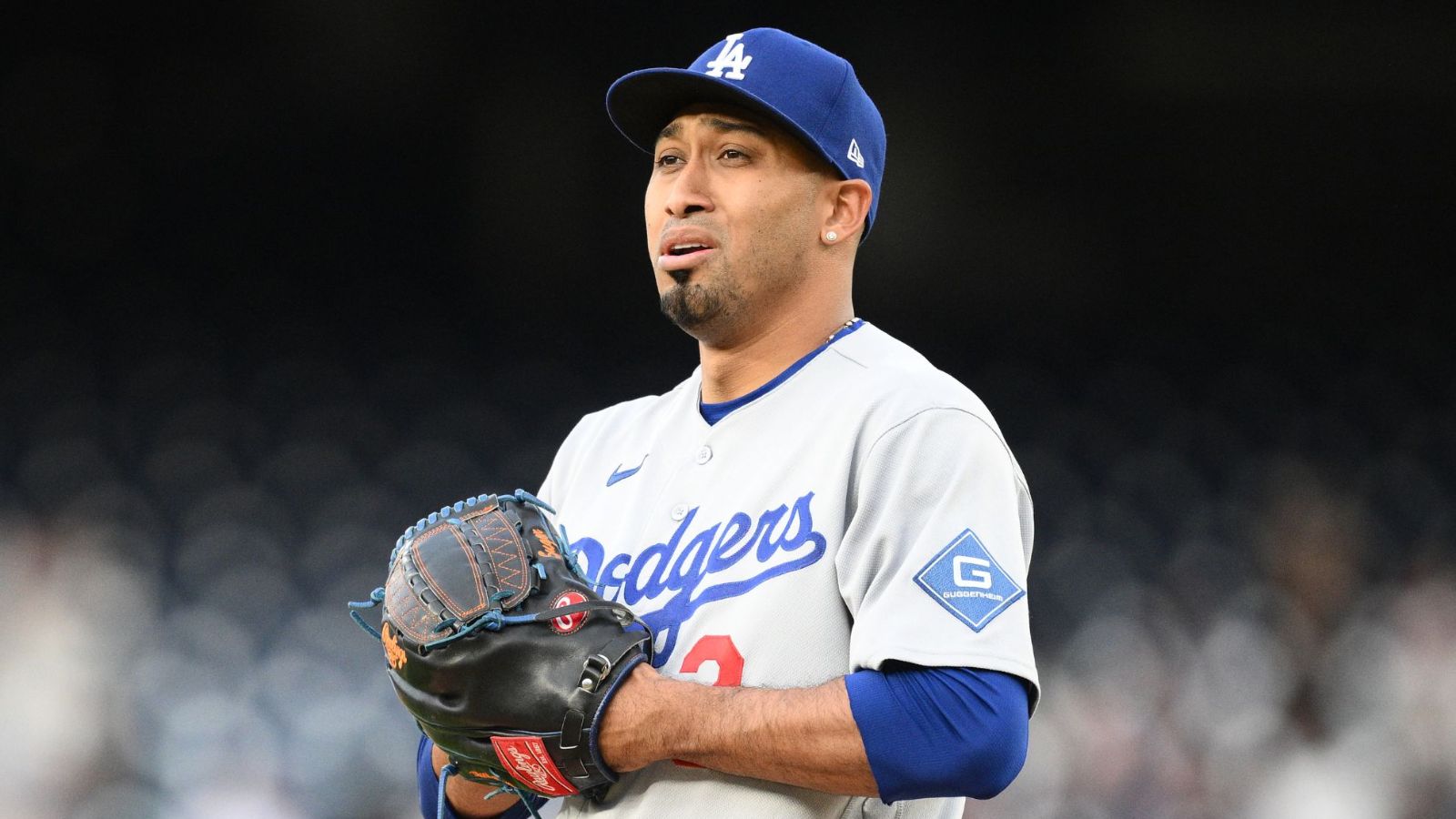 Díaz looking concerned while holding his glove during a game