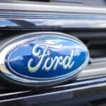 The front end of a Ford vehicle, showing its headlights and the company's logo