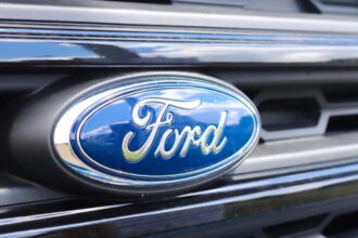 The front end of a Ford vehicle, showing its headlights and the company's logo