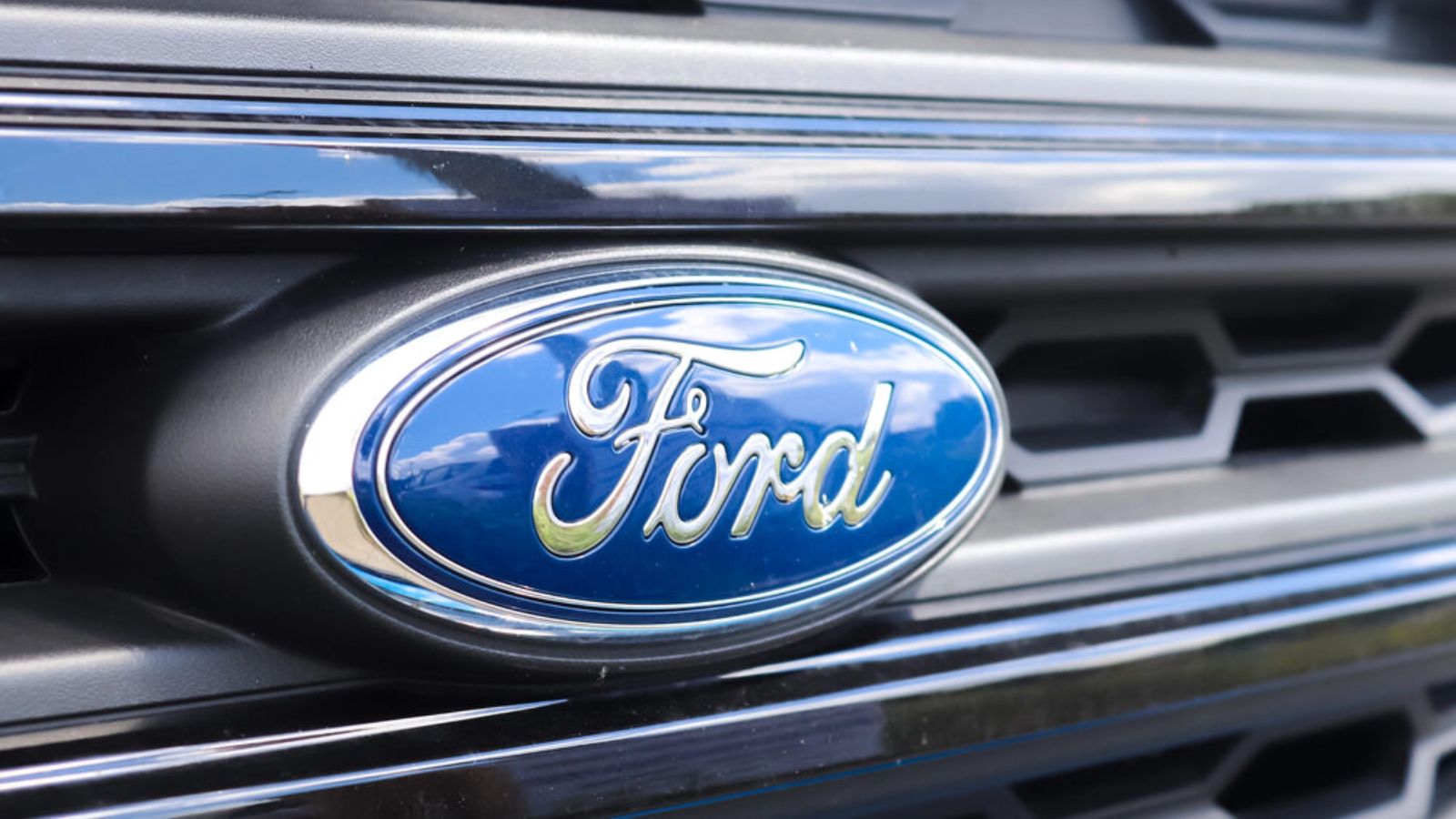The front end of a Ford vehicle, showing its headlights and the company's logo