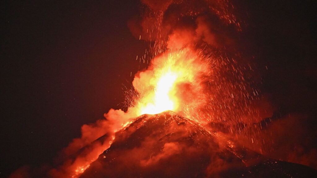 "A volcano in the middle of an eruption, sending massive amounts of lava high into the air