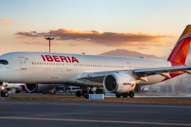 An Iberia Airlines plane parked and boarding passengers