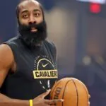 The Cavaliers forward holding the ball while wearing his team's practice uniform