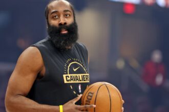 The Cavaliers forward holding the ball while wearing his team's practice uniform