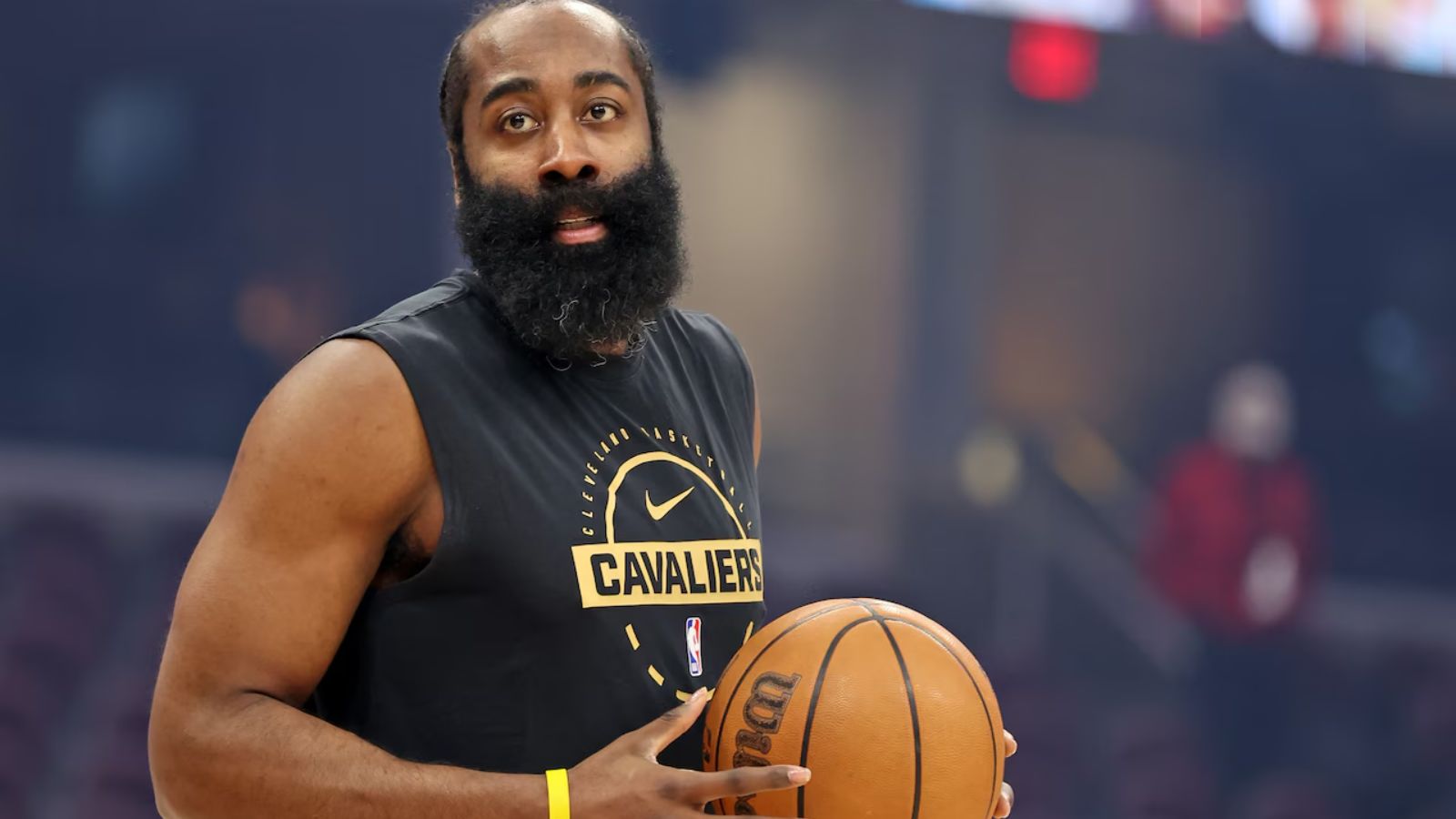 The Cavaliers forward holding the ball while wearing his team's practice uniform