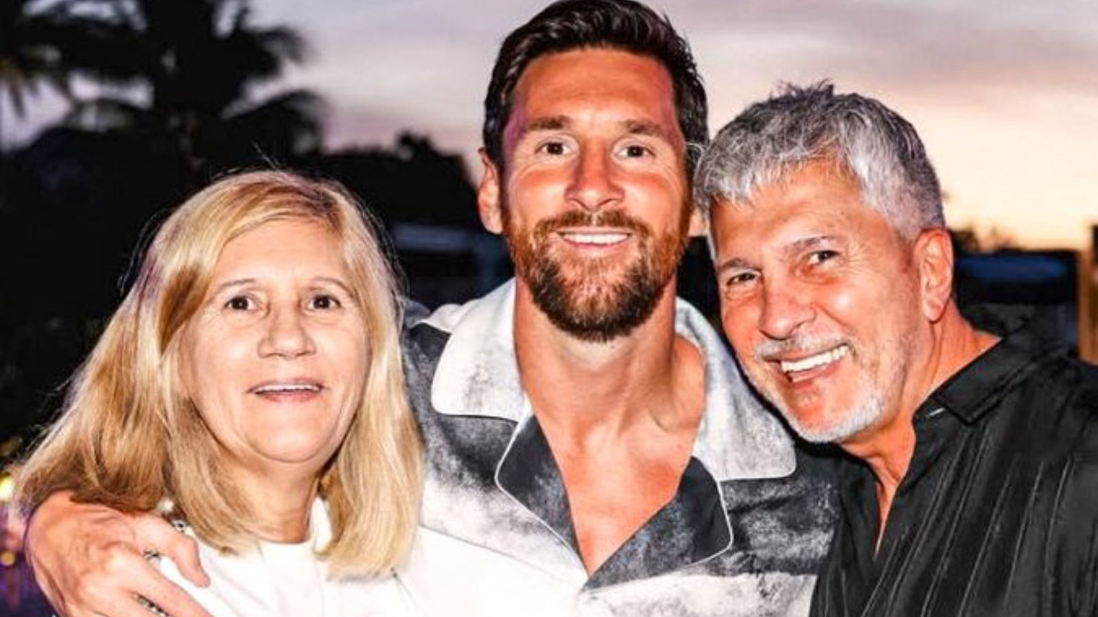 A photo of Messi with his mother and father sharing a warm embrace