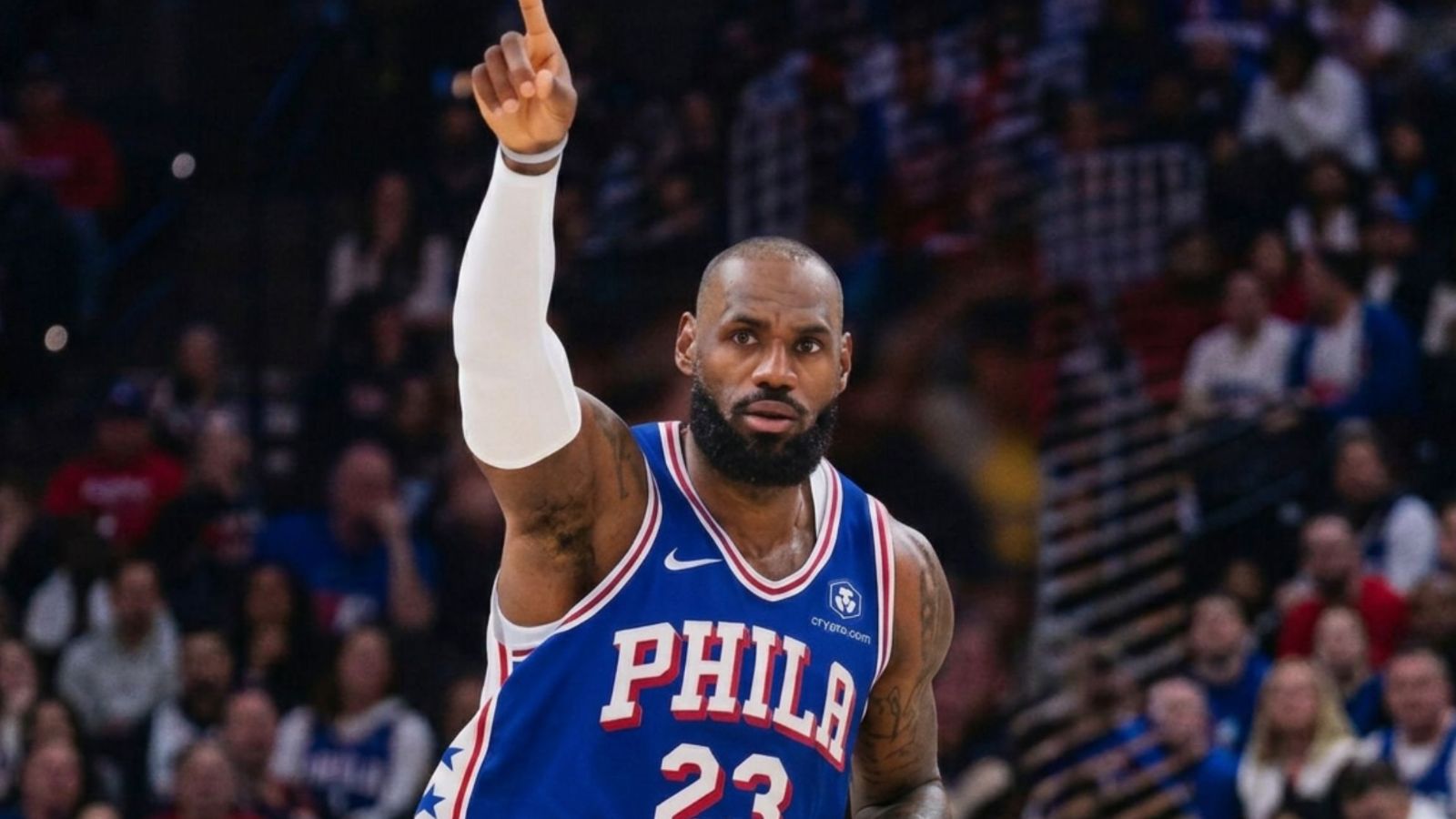 An image of the King wearing a Philadelphia jersey with the number 23, raising his hand after scoring a point