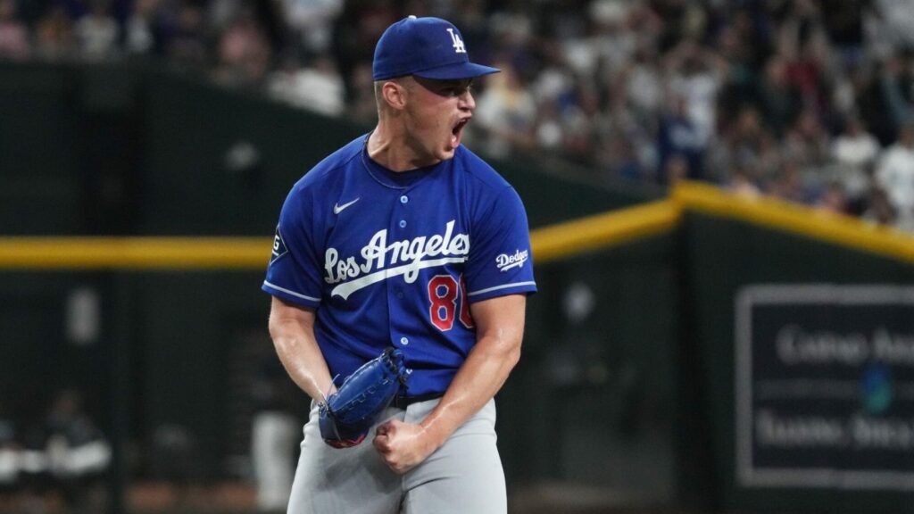 Dodgers pitcher Meyer celebrating enthusiastically after pitching and recording two outs to secure the victory