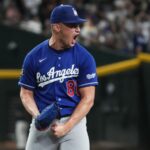 Dodgers pitcher Meyer celebrating enthusiastically after pitching and recording two outs to secure the victory