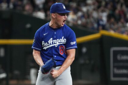 Dodgers pitcher Meyer celebrating enthusiastically after pitching and recording two outs to secure the victory