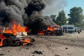 Two cars completely engulfed in flames following the attacks