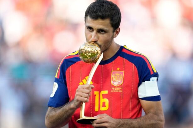 The Spanish midfielder holding and kissing the World Cup Ballon d’Or after becoming champion with his national team