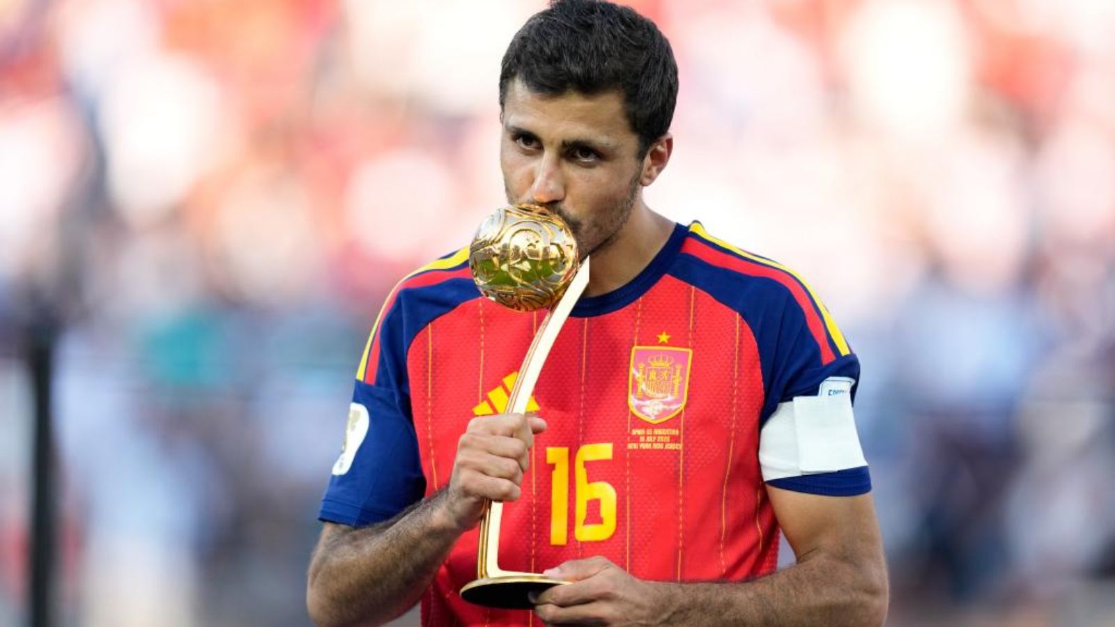 The Spanish midfielder holding and kissing the World Cup Ballon d’Or after becoming champion with his national team