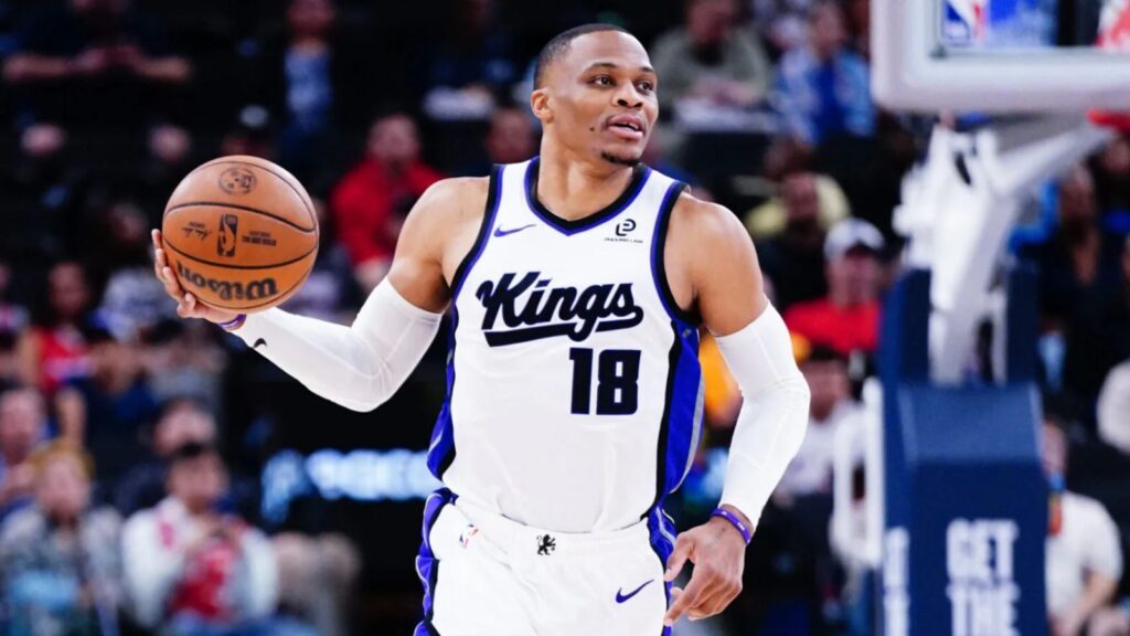 The NBA MVP point guard holding the ball while running during a game with the Sacramento Kings