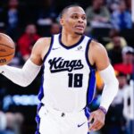 The NBA MVP point guard holding the ball while running during a game with the Sacramento Kings