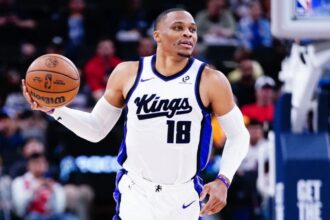 The NBA MVP point guard holding the ball while running during a game with the Sacramento Kings