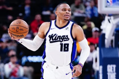 The NBA MVP point guard holding the ball while running during a game with the Sacramento Kings