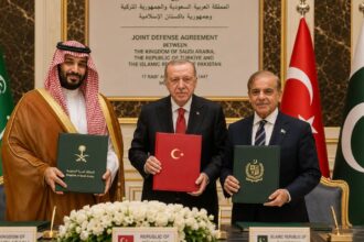 The three leaders of the major nations posing together for a photo while holding the signed agreements