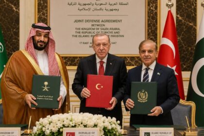 The three leaders of the major nations posing together for a photo while holding the signed agreements