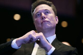 Elon Musk with a very serious expression during a press conference
