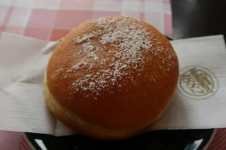 The viral pastry bringing hundreds of tourists to a Dolomites Mountain refuge The delicious dessert placed on a table with a checkered tablecloth