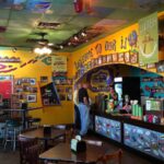 A view of a traditional Mexican restaurant featuring colorful décor, vibrant murals, handcrafted ornaments, and authentic elements inspired by Mexican culture and heritage