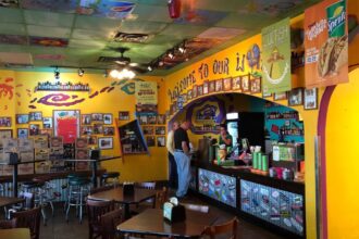 A view of a traditional Mexican restaurant featuring colorful décor, vibrant murals, handcrafted ornaments, and authentic elements inspired by Mexican culture and heritage