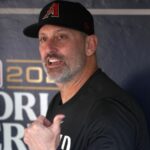 The Diamondbacks manager sitting in the dugout, talking very loudly to someone