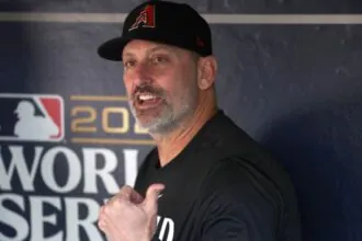 The Diamondbacks manager sitting in the dugout, talking very loudly to someone