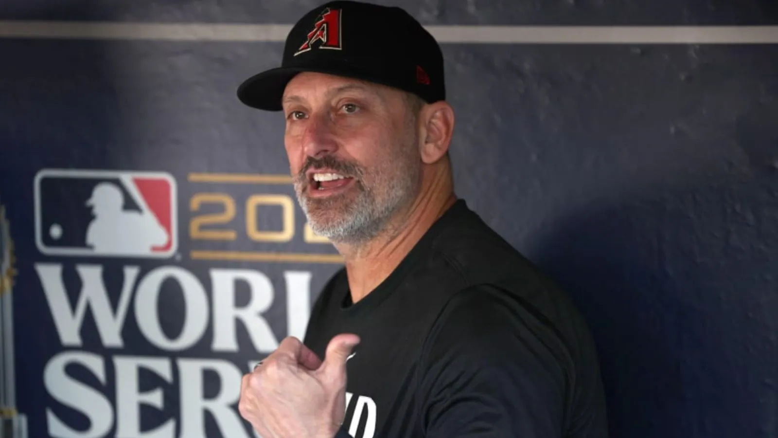 The Diamondbacks manager sitting in the dugout, talking very loudly to someone