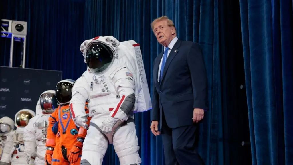 Trump walking through the halls of NASA, looking at astronauts' suits