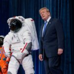 Trump pushes for new space academy to train the next generation of americans Trump walking through the halls of NASA, looking at astronauts' suits