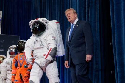 Trump walking through the halls of NASA, looking at astronauts' suits