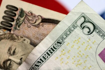 Two banknotes, one a 5-dollar bill and the other a 10,000-yen note, placed one on top of the other
