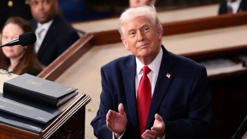 Donald Trump looking at the United States flag as a symbol of respect for his nation