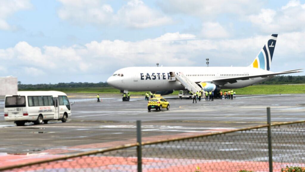 An airplane being boarded by several people who will be deported to Liberia
