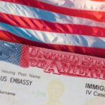 A United States visa placed on top of an American flag