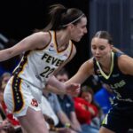Two WNBA players battling it out during a game for a chance to advance to the next round