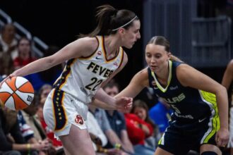 Two WNBA players battling it out during a game for a chance to advance to the next round