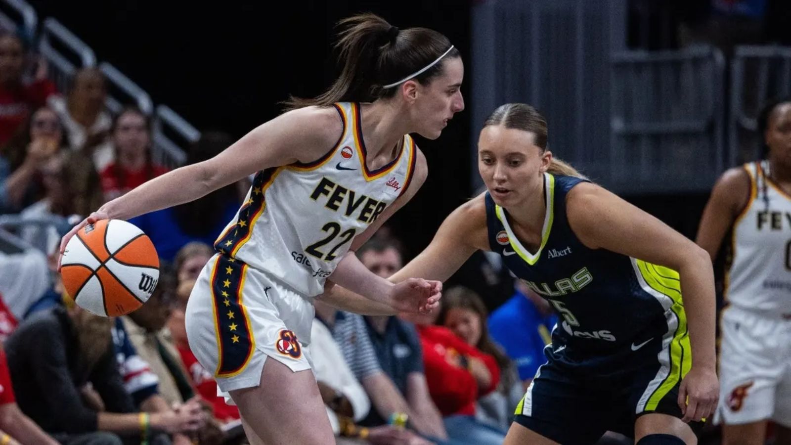 Two WNBA players battling it out during a game for a chance to advance to the next round