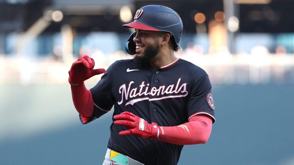 The explosive player celebrating a big hit while looking toward his teammates in the dugout