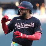 The explosive player celebrating a big hit while looking toward his teammates in the dugout