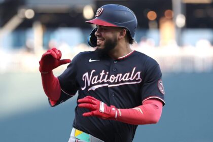 The explosive player celebrating a big hit while looking toward his teammates in the dugout