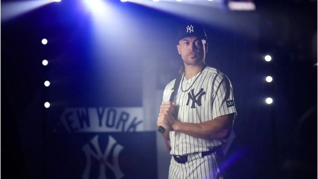 Stanton posing with his bat for a promotional photo shoot with his team